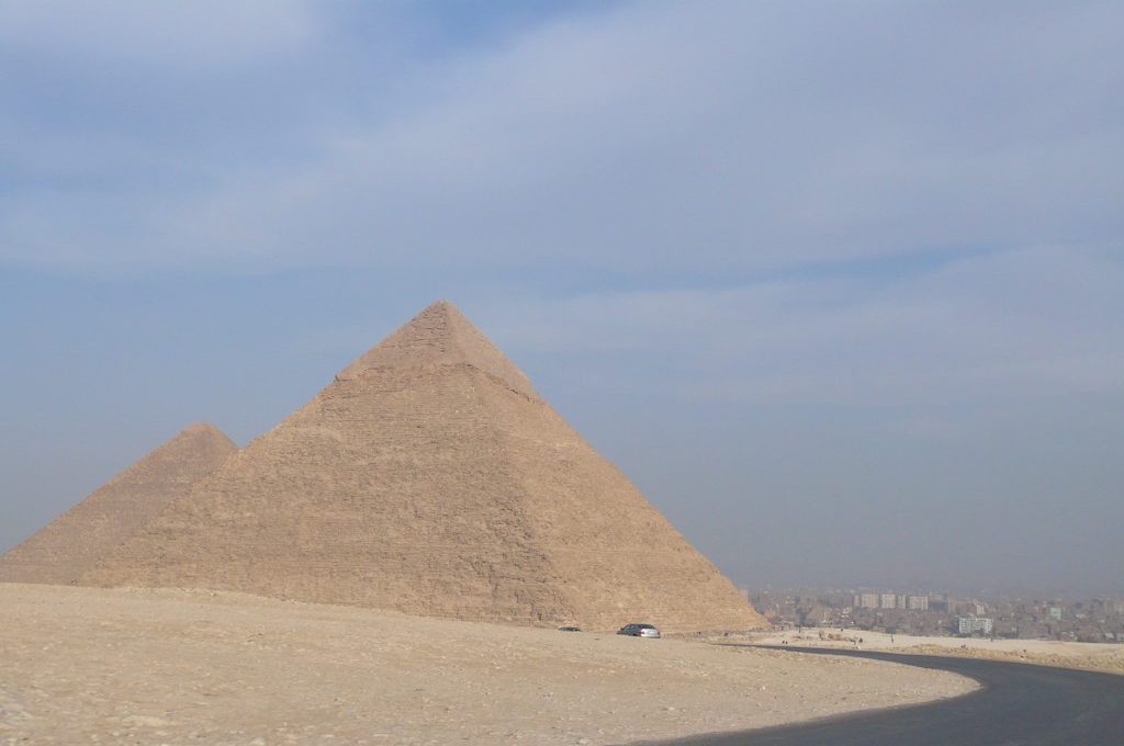 Blick auf das Pyramidenplateau von Gizeh mit Straße und Stadt Kairo